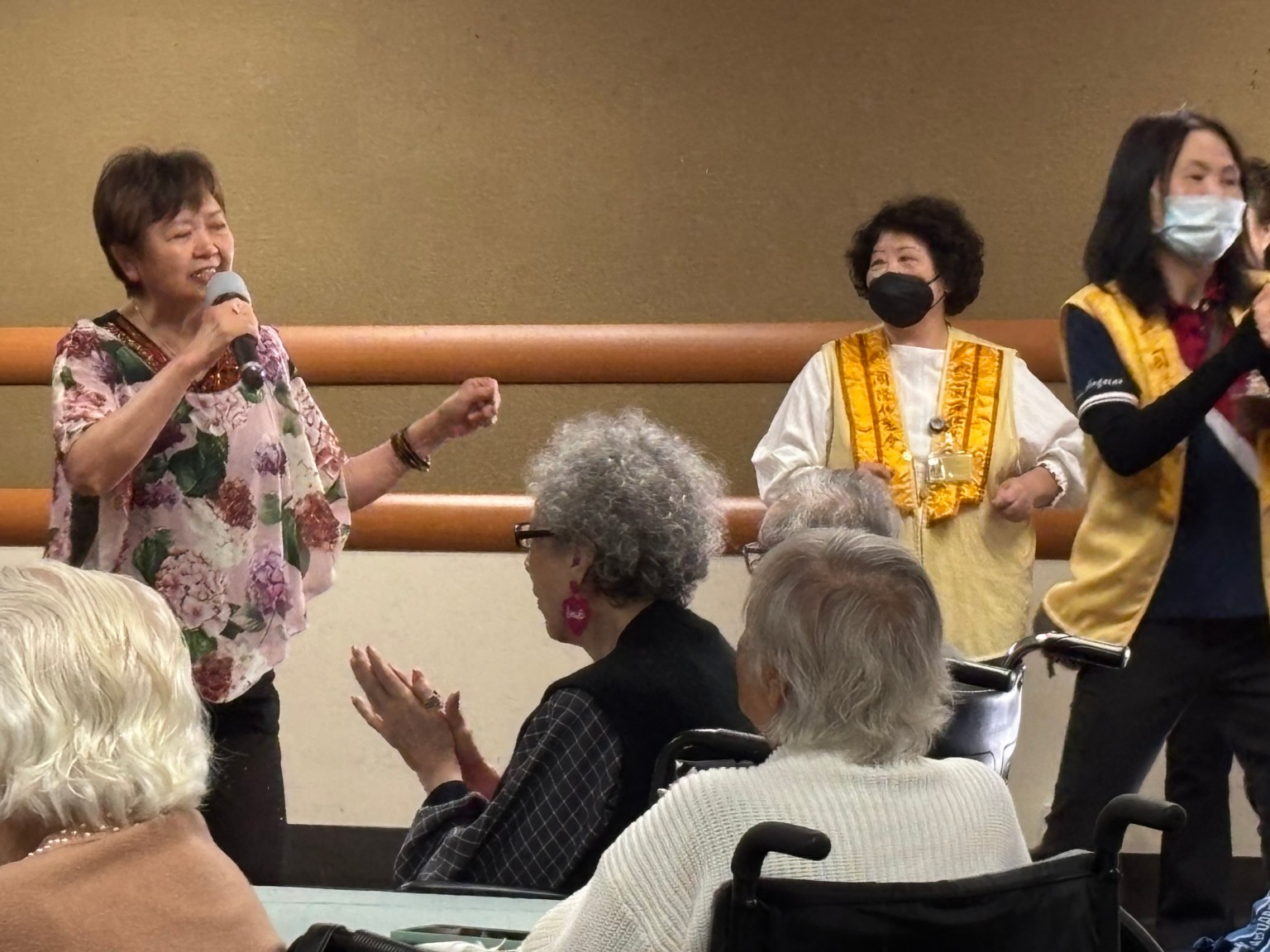 載眼鏡的長者，跟著音樂節奏拍手