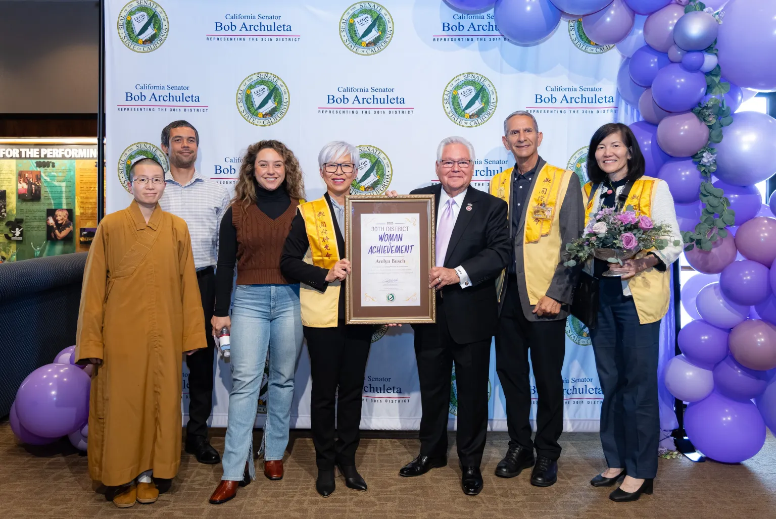 Avelyn Busch (4th from left), representing Hsi Lai Temple of Fo Guang Shan, takes a commemorative photo after receiving her award with Senator Archuleta (3rd from right), Venerable Zhixing (1st from left), her son Colin Busch (2nd from left), daughter Caitlen Busch (3rd from left), husband Neal Golub (2nd from right), and BLIA Los Angeles Chapter President Echo Tsai (1st from right).