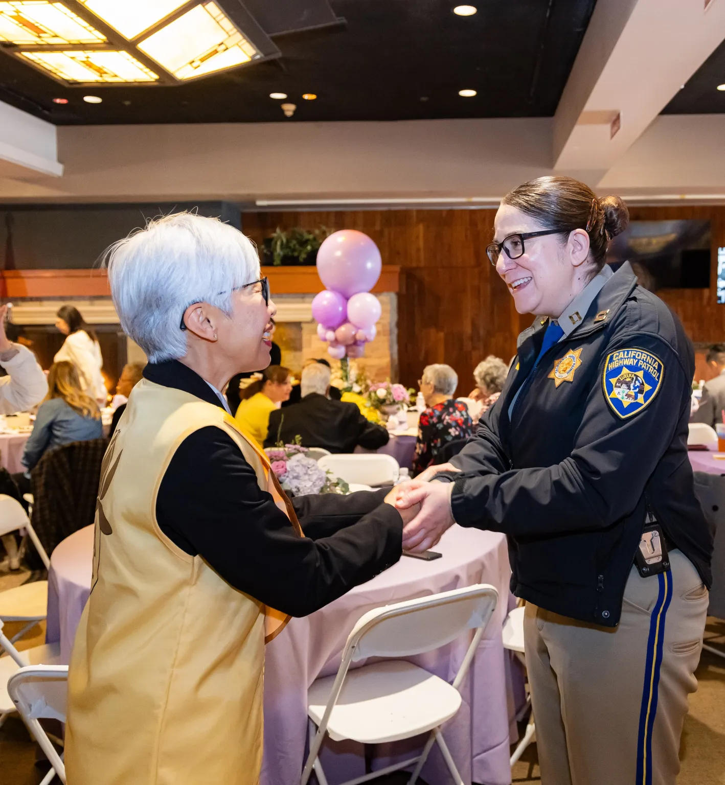 Melissa Hammond, Captain of the California Highway Patrol (CHP) Santa Fe Springs Division, congratulates Avelyn Busch on receiving the award.