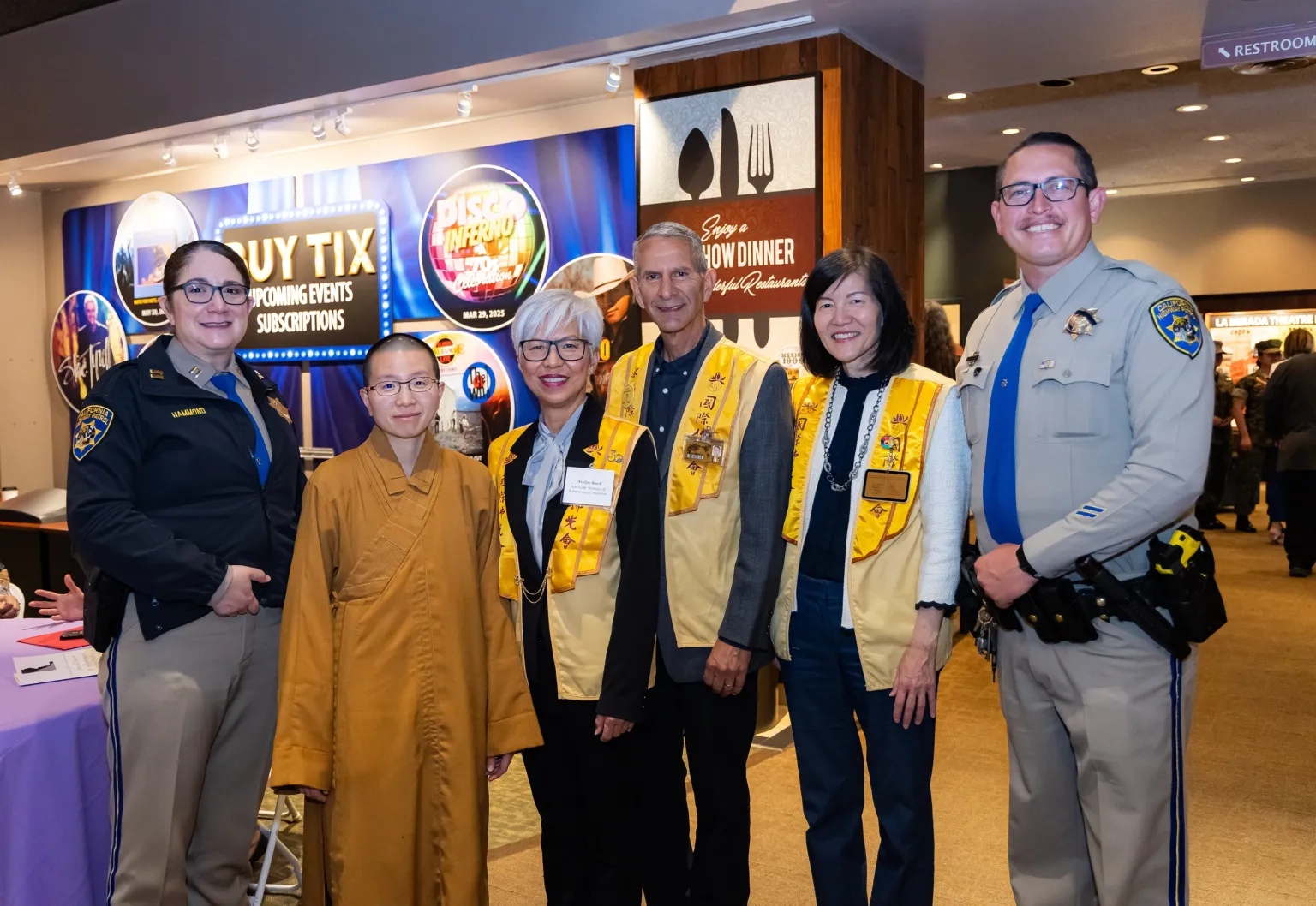 Avelyn Busch (3rd from left), her husband, Venerable Zhixing (2nd from left), Echo Tsai (2nd from right), and CHP Santa Fe Springs Captain Melissa Hammond (1st from left) take a group photo.