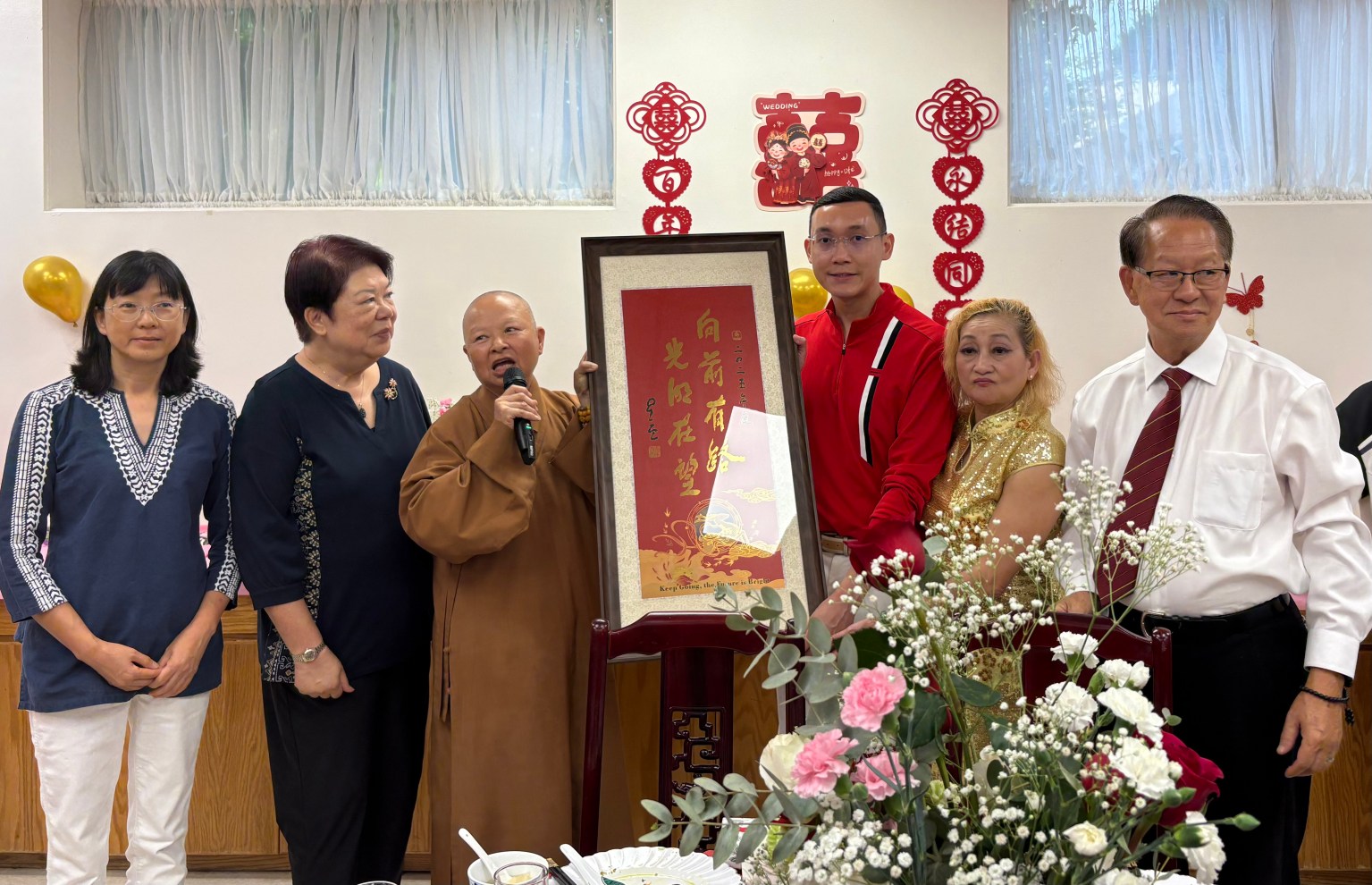 滿燈法師代表西來寺住持贈送星雲大師墨寶「向前有路，光明在望」給吳美娟師姐全家