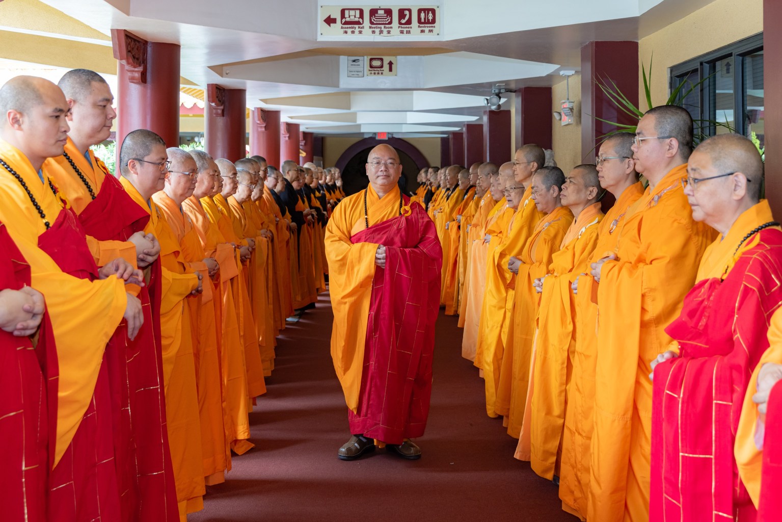 Most Venerable Abbot Hsin Bau of Fo Guang Shan leads 90 North American monastics in formation along the corridor.