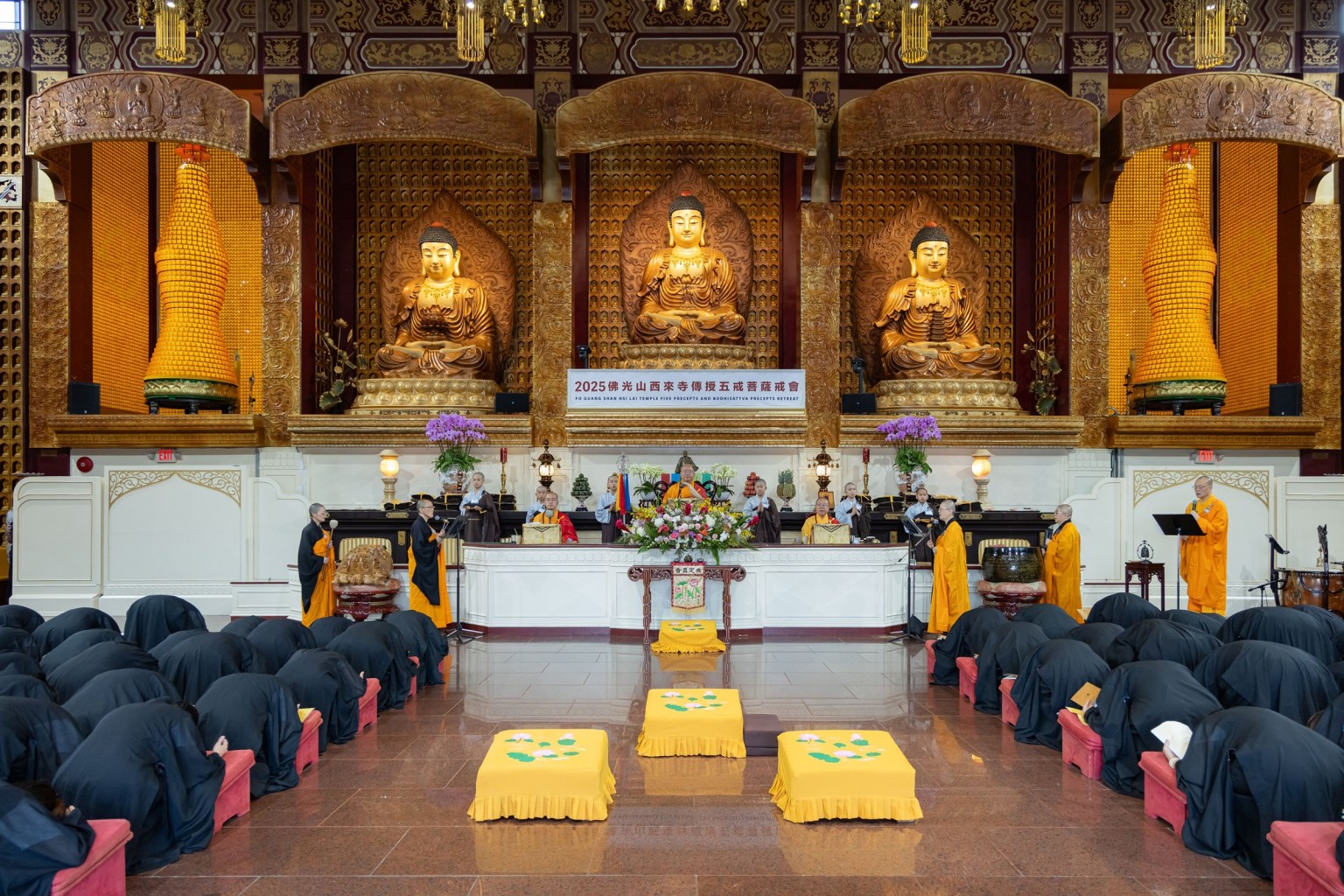 The precept platform at Hsi Lai Temple: Venerable Hsin Bau (center) as Precept Master, Venerable Hui Kai (right) as Karma Acarya, and Venerable Hui Dong (left) as Teaching Master.