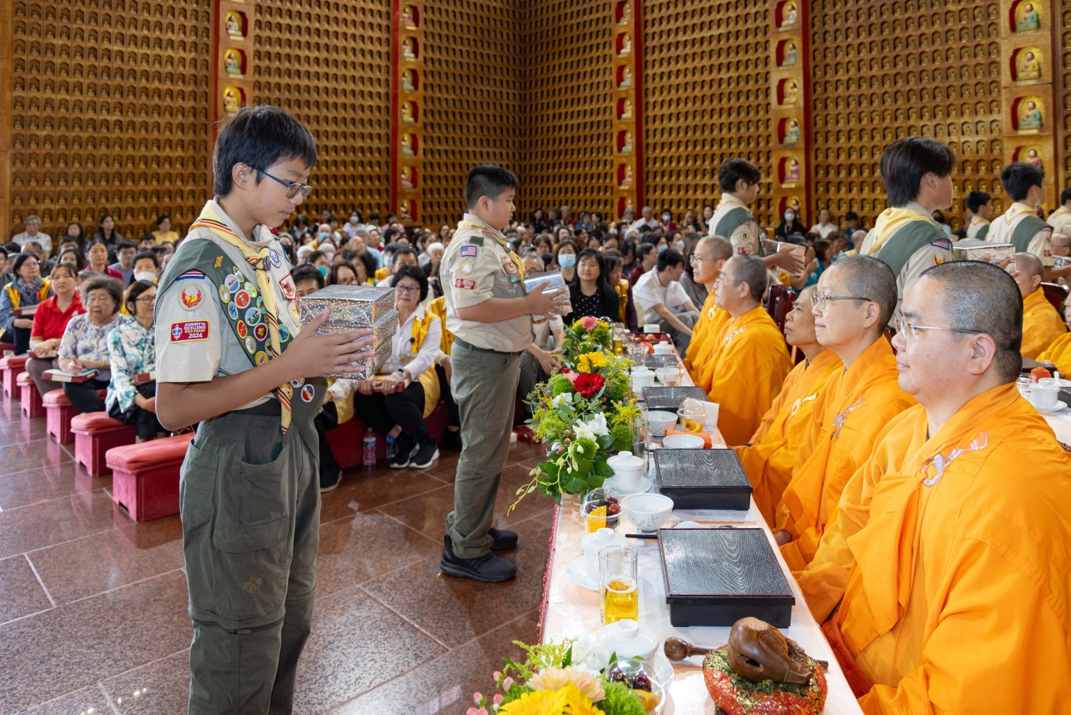 Hsi Lai Scout Troop presents beautifully prepared gifts to the monastics.