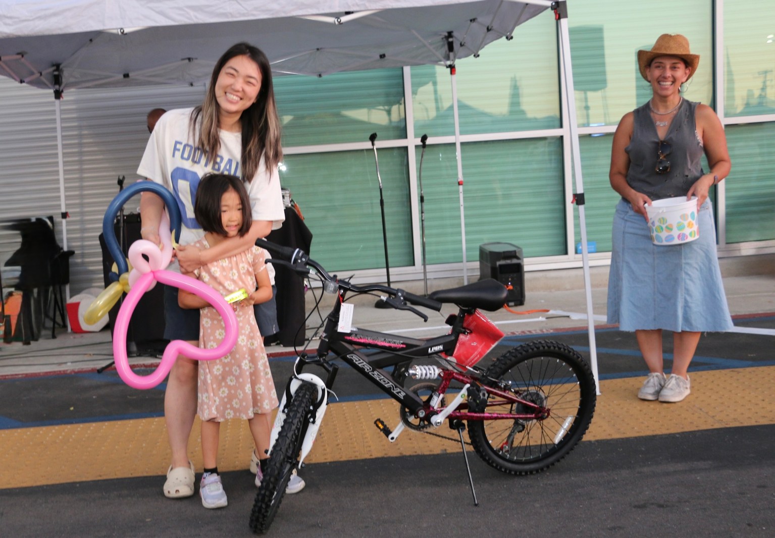 National Night Out concludes with a raffle drawing for two bicycles, bringing the event to a joyful close amid laughter.