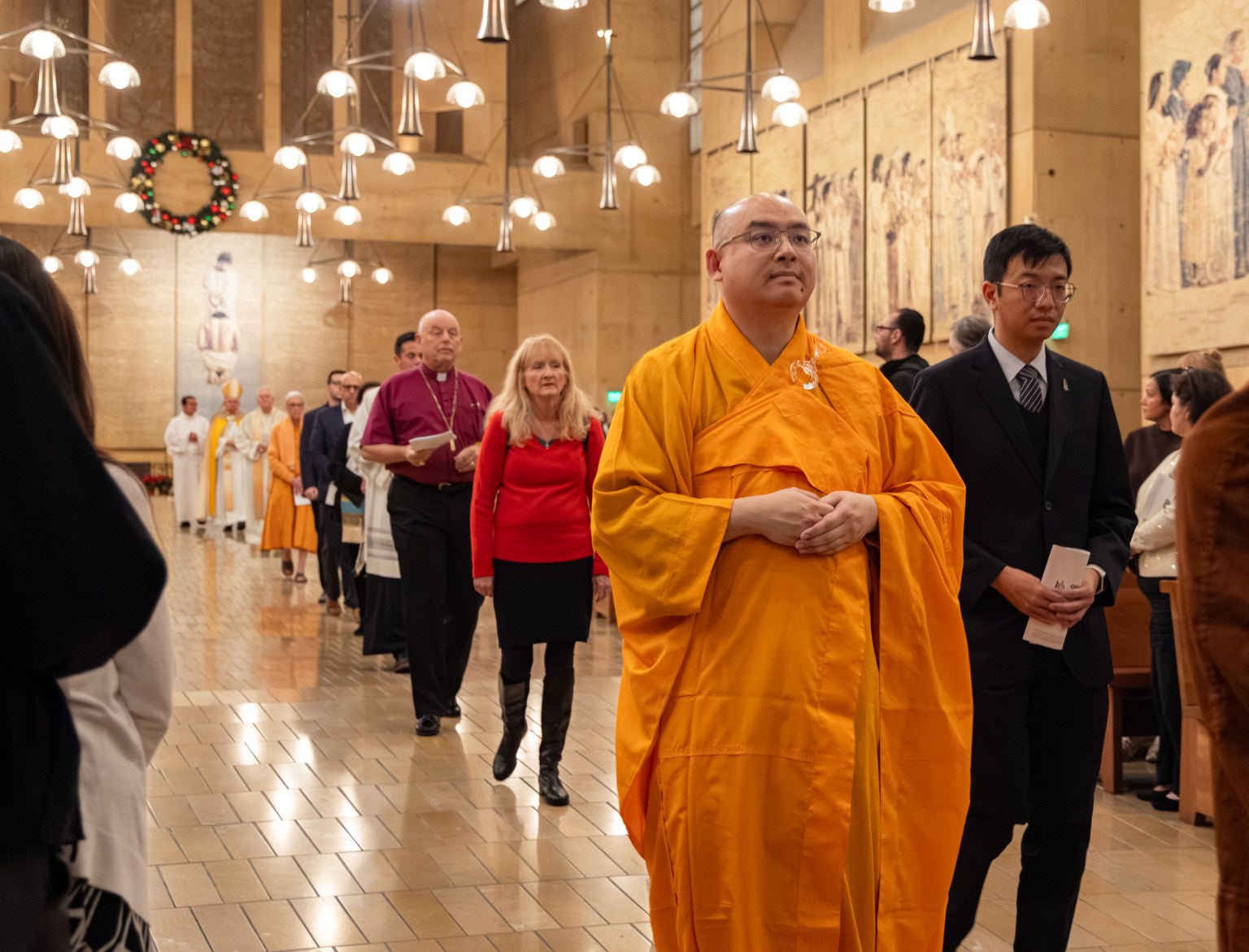 Venerable Huize (first from right) enters the venue together with representatives of various faiths, beginning an interfaith memorial prayer service.
