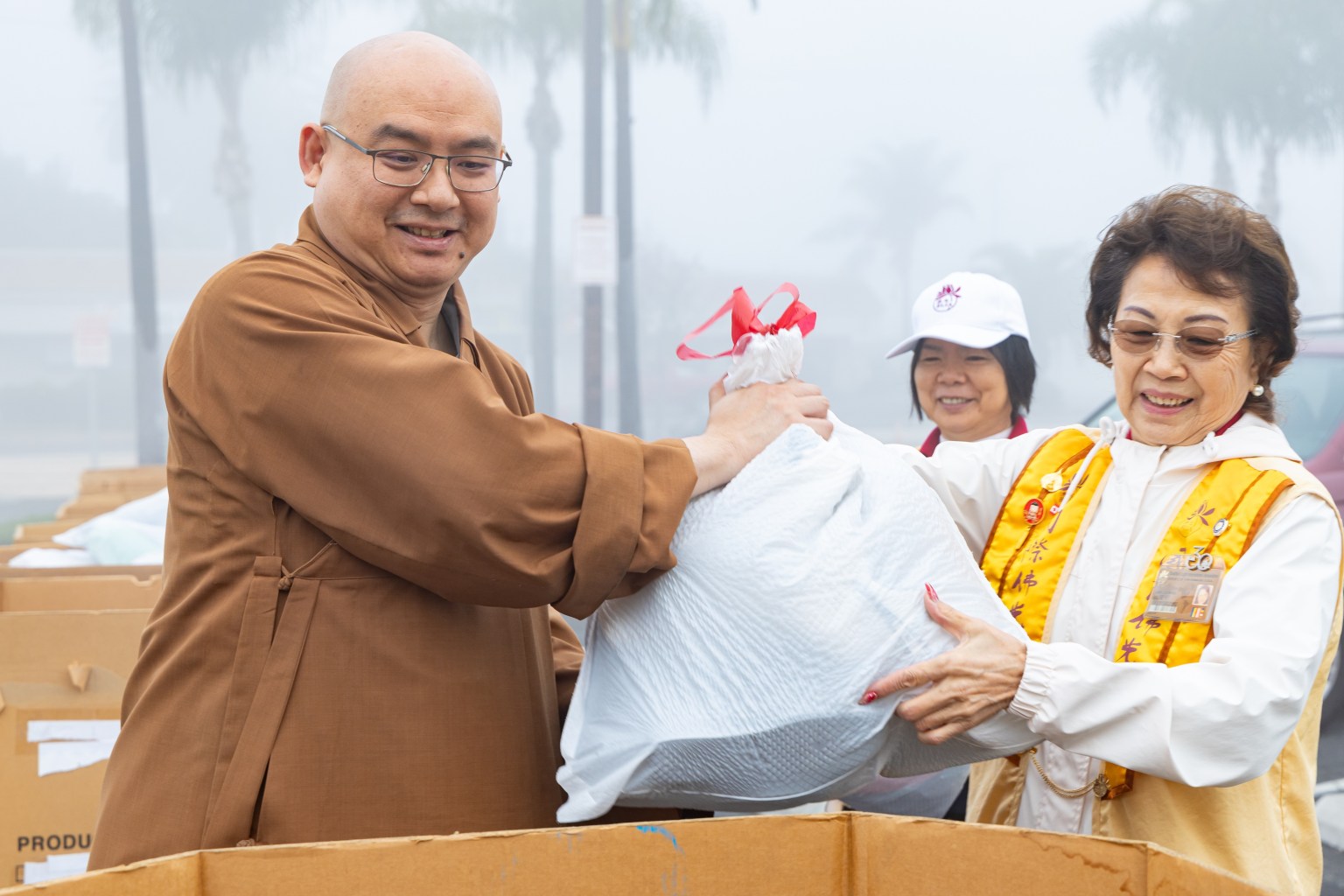 Venerable Huize (left) and Director Lin Lu-Ming (right) work together to receive donated clothing.