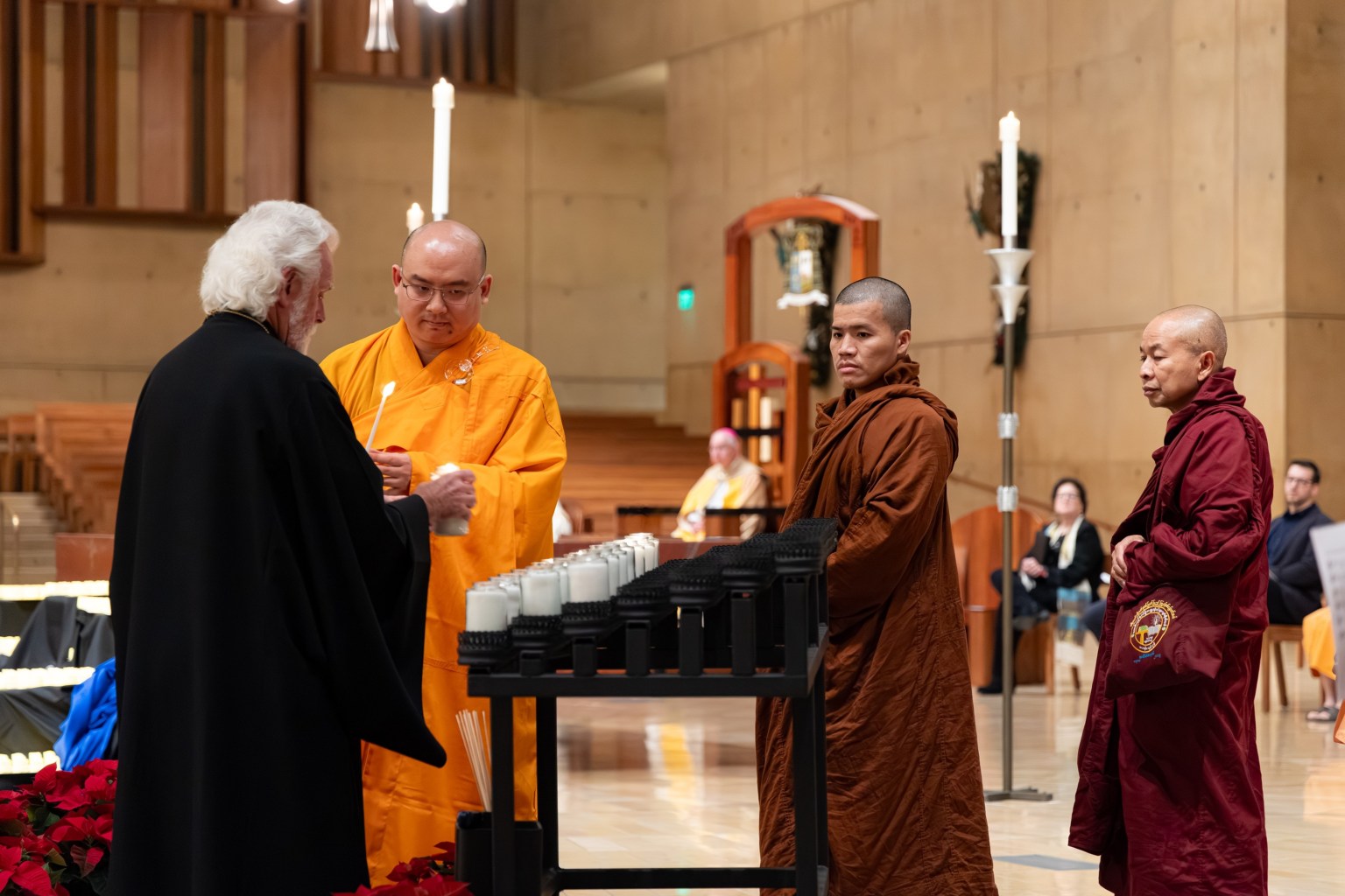 Venerable Huize (right) and representatives of various faiths light candles in prayer for the deceased unhoused individuals.