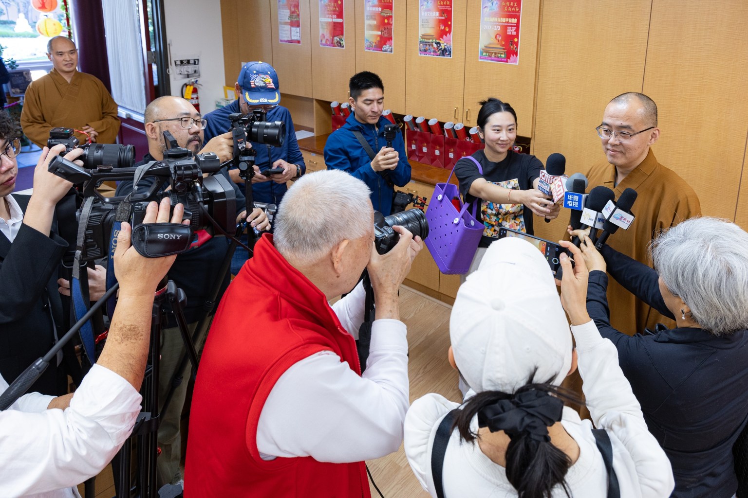 Venerable Huidong is interviewed by members of the media.
