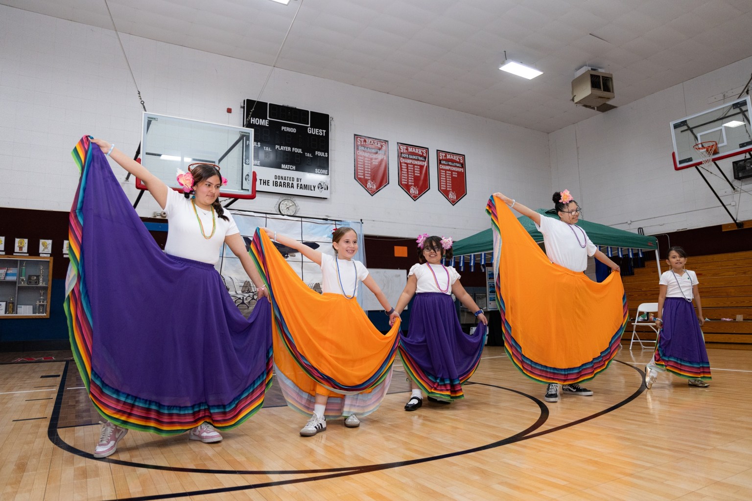 Girl Scouts representing Nicaragua dance joyfully in traditional attire.