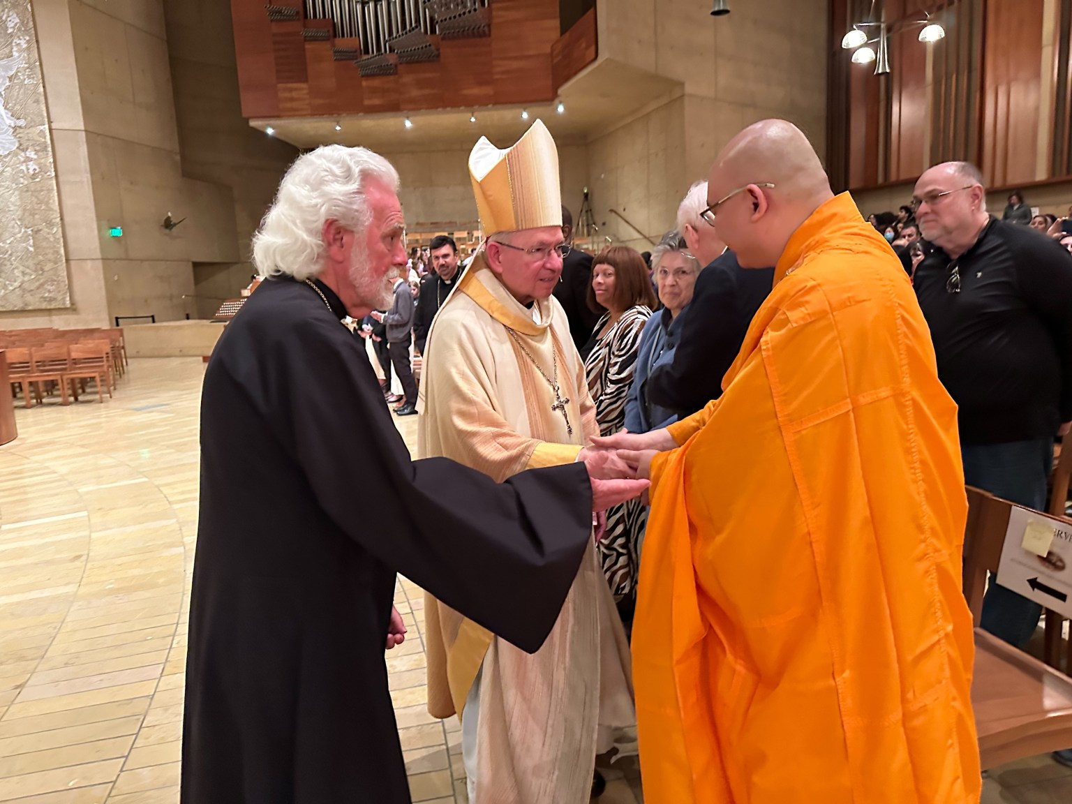 Following the ceremony, Venerable Huize greets Archbishop Gomez with a handshake.